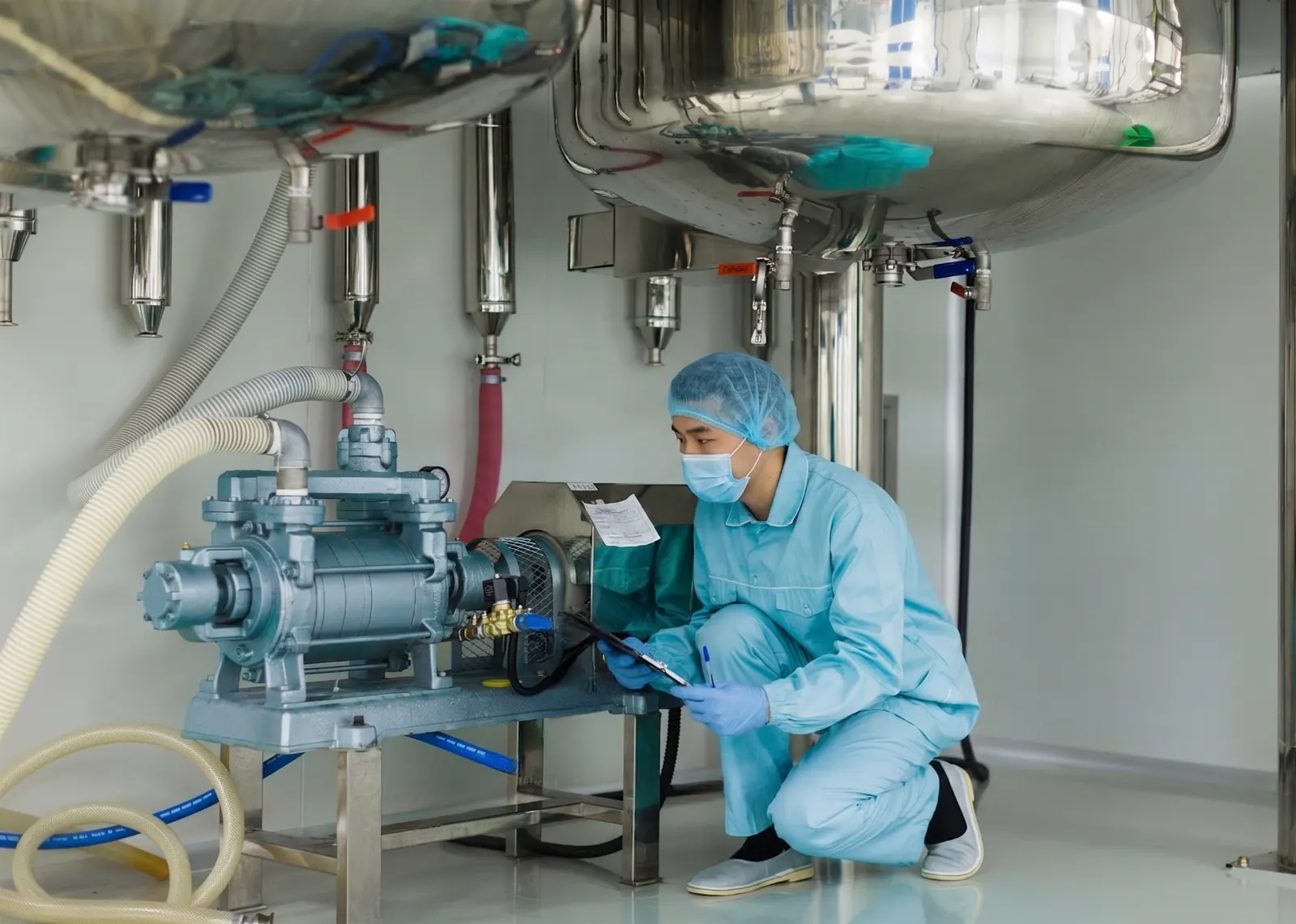 Technician inspecting compressed-air and process utilities
